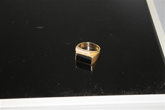 A 14k yellow metal, diamond and black onyx set dress ring, size U/V, gross weight 8.4 grams.